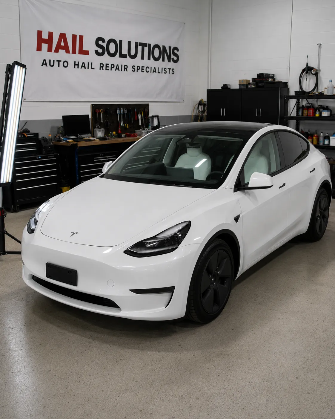 2022 Tesla Model Y — Pearl White Multi-Coat hail damage repair in Leawood, KS